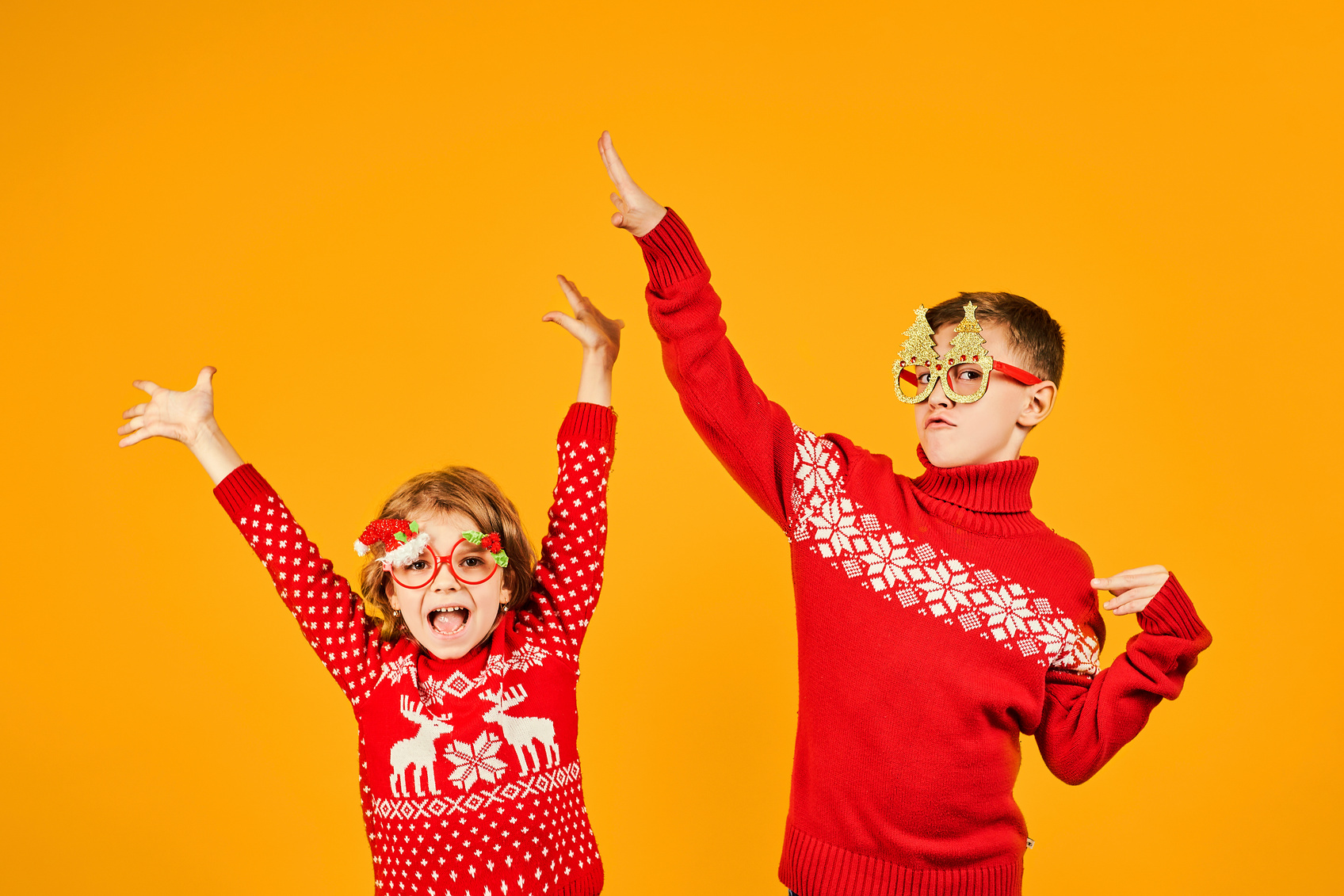 Children in warm red Christmas sweaters